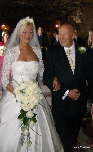 the bride wearing the finished wedding dress