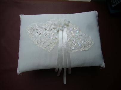 Two beaded lace hearts with dainty flowers and white ribbons on this charming romantic white ring cushion. From a selection of ready made ring cushions - or have a ring cushion custom made.